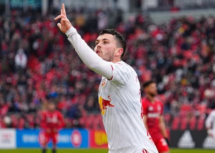 Mar 5, 2022; Toronto, Ontario, CAN; New York Red Bulls midfielder Lewis Morgan (10) signals three goals to the Toronto FC fans after scoring a hat trick in the first half at BMO Field. Mandatory Credit: John E. Sokolowski-USA TODAY Sports