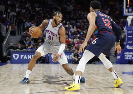 Mar 31, 2022; Detroit, Michigan, USA;  Detroit Pistons forward Saddiq Bey (41) dribbles defended by Philadelphia 76ers forward Tobias Harris (12) in the second half at Little Caesars Arena. Mandatory Credit: Rick Osentoski-USA TODAY Sports