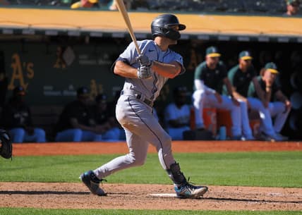 Sep 22, 2022; Oakland, California, USA; Seattle Mariners second baseman Adam Frazier (26) hits an RBI single against the Oakland Athletics during the eighth inning at RingCentral Coliseum. Mandatory Credit: Kelley L Cox-USA TODAY Sports