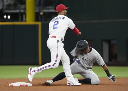 Oct 3, 2022; Arlington, Texas, USA; Texas Rangers second baseman Marcus Semien (2) forces out New York Yankees shortstop Oswald Peraza (91) during the fifth inning at Globe Life Field. Mandatory Credit: Jim Cowsert-USA TODAY Sports