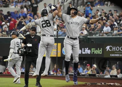 Oct 3, 2022; Arlington, Texas, USA; New York Yankees designated hitter Giancarlo Stanton (right) celebrates his home run with third baseman Josh Donaldson (28) against the Texas Rangers during the eighth inning at Globe Life Field. The Yankees won 3-1. Mandatory Credit: Jim Cowsert-USA TODAY Sports