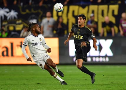 Oct 20, 2022; Los Angeles, California, US; Los Angeles FC forward Carlos Vela (10) battles against Los Angeles Galaxy forward Raheem Edwards (44) during the first half of the MLS Cup Playoff semifinal at Banc Of California Stadium. Mandatory Credit: Gary A. Vasquez-USA TODAY Sports