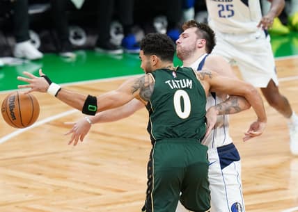 Nov 23, 2022; Boston, Massachusetts, USA; Dallas Mavericks guard Luka Doncic (77) works for the ball against Boston Celtics forward Jayson Tatum (0) in the fourth quarter at TD Garden. Mandatory Credit: David Butler II-USA TODAY Sports