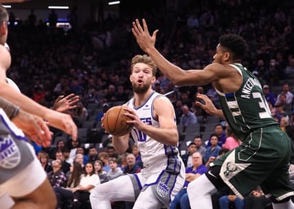 Mar 16, 2022; Sacramento, California, USA; Sacramento Kings center Domantas Sabonis (10) controls the ball against Milwaukee Bucks forward Giannis Antetokounmpo (34) during the first quarter at Golden 1 Center. Mandatory Credit: Kelley L Cox-USA TODAY Sports