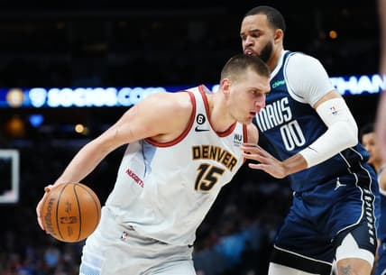 Feb 15, 2023; Denver, Colorado, USA; Dallas Mavericks center JaVale McGee (00) defends Denver Nuggets center Nikola Jokic (15) in the first quarter at Ball Arena. Mandatory Credit: Ron Chenoy-USA TODAY Sports