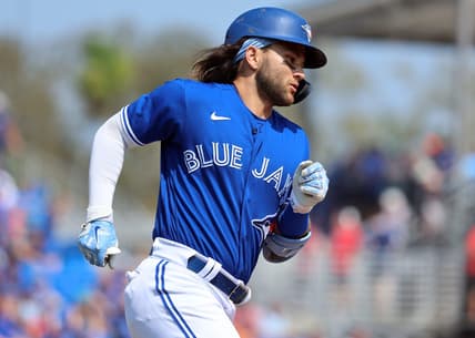 Mar 13, 2023; Dunedin, Florida, USA;  Toronto Blue Jays shortstop Bo Bichette (11) hits a home run against the Boston Red Sox during the fourth inning at TD Ballpark. Mandatory Credit: Kim Klement-USA TODAY Sports