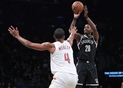 Mar 21, 2023; Brooklyn, New York, USA; Brooklyn Nets forward Dorian Finney-Smith (28) shoots the ball against Cleveland Cavaliers forward Evan Mobley (4) during the second half at Barclays Center. Mandatory Credit: Vincent Carchietta-USA TODAY Sports