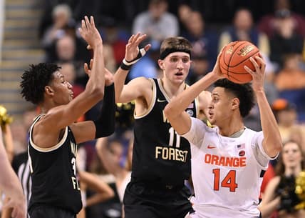 Mar 8, 2023; Greensboro, NC, USA; Syracuse Orange center Jesse Edwards (14) with the ball as Wake Forest Demon Deacons forward Bobi Klintman (34) and forward Andrew Carr (11) defend in the first half of the second round at Greensboro Coliseum. Mandatory Credit: Bob Donnan-USA TODAY Sports
