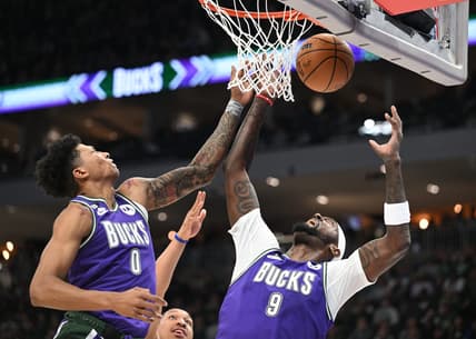 Mar 30, 2023; Milwaukee, Wisconsin, USA; Milwaukee Bucks guard MarJon Beauchamp (0) and Milwaukee Bucks forward Bobby Portis (9) battle for a rebound in the second half at Fiserv Forum. Mandatory Credit: Michael McLoone-USA TODAY Sports
