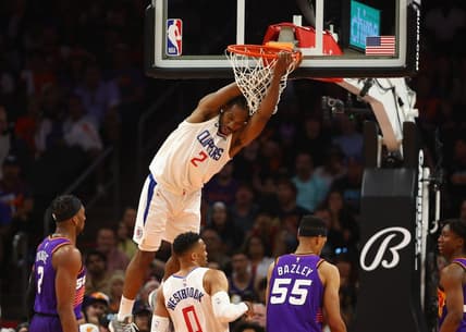 Apr 9, 2023; Phoenix, Arizona, USA; Los Angeles Clippers forward Kawhi Leonard (2) hangs from the rim after a slam dunk against the Phoenix Suns in the second half at Footprint Center. Mandatory Credit: Mark J. Rebilas-USA TODAY Sports