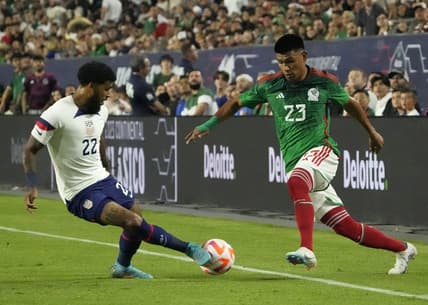 Apr 19, 2023; Glendale, Ariz., U.S.;  United States defender DeAndre Yedlin (22) kicks the ball away from Mexico defender Jesus Gallardo (23) during the Allstate Continental Classico at State Farm Stadium. Mandatory Credit: Michael Chow-Arizona Republic

Soccer U S Mexico Men S Soccer