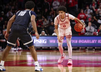 Nov 15, 2023; Piscataway, New Jersey, USA; Rutgers Scarlet Knights guard Derek Simpson (0) dribbles as Georgetown Hoyas guard Jayden Epps (10) defends during the second half at Jersey Mike's Arena. Mandatory Credit: Vincent Carchietta-USA TODAY Sports