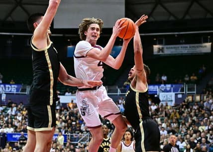Nov 20, 2023; Honolulu, Hawaii, USA;  Gonzaga Bulldogs guard Dusty Stromer (4) drives to the basket defended by Purdue Boilermakers center Zach Edey (15) and forward Mason Gillis (0) during the second half at SimpliFi Arena at Stan Sheriff Center. Mandatory Credit: Steven Erler-USA TODAY Sports