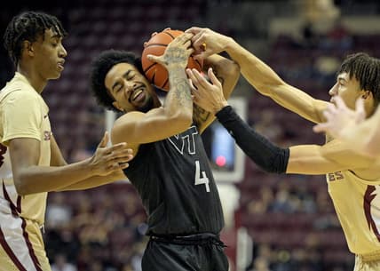 Jan 6, 2024; Tallahassee, Florida, USA; Virginia Tech Hokies forward Mekhi Long (4) wrestles a ball away from Florida State Seminoles guard Jalen Warley (1) during the game at Donald L. Tucker Center. Mandatory Credit: Melina Myers-USA TODAY Sports