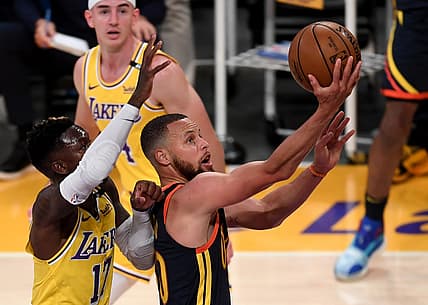 May 19, 2021; Los Angeles, California, USA;   Golden State Warriors guard Stephen Curry (30) gets past Los Angeles Lakers guard Dennis Schroder (17) and Los Angeles Lakers guard Alex Caruso (4) as he drives to the basket in the first half of the game at Staples Center. Mandatory Credit: Jayne Kamin-Oncea-USA TODAY Sports
