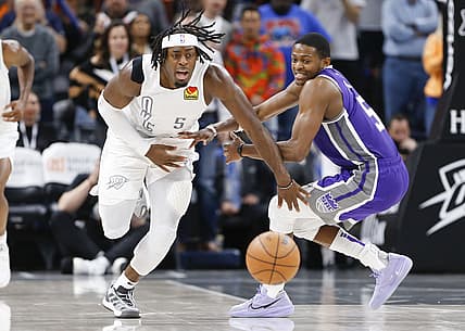 Nov 12, 2021; Oklahoma City, Oklahoma, USA; Oklahoma City Thunder forward Luguentz Dort (5) runs after a loose ball ahead of Sacramento Kings guard De'Aaron Fox (5) during the fourth quarter at Paycom Center. Oklahoma City won 105-103. Mandatory Credit: Alonzo Adams-USA TODAY Sports