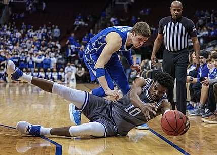 Feb 4, 2022; Newark, New Jersey, USA; Seton Hall Pirates forward Alexis Yetna (10) reaches for a loose ball during the second half in front of Creighton Bluejays guard John Christofilis (15) at Prudential Center. Mandatory Credit: Vincent Carchietta-USA TODAY Sports