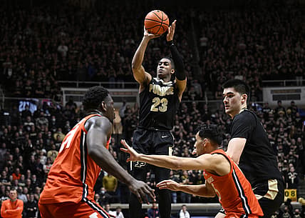 Feb 8, 2022; West Lafayette, Indiana, USA; Purdue Boilermakers guard Jaden Ivey (23) takes a shot over Illinois Fighting Illini center Kofi Cockburn (21) during the second half at Mackey Arena. Boilermakers won 84-68. Mandatory Credit: Marc Lebryk-USA TODAY Sports