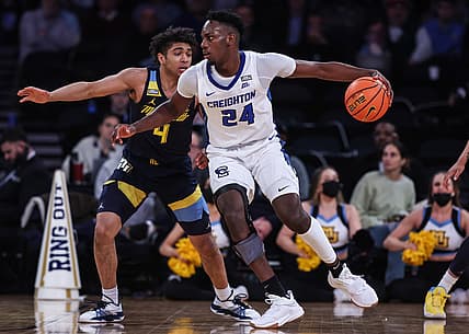 Mar 10, 2022; New York, NY, USA; Creighton Bluejays forward Arthur Kaluma (24) dribbles against Marquette Golden Eagles guard Stevie Mitchell (4) during the first half at Madison Square Garden. Mandatory Credit: Vincent Carchietta-USA TODAY Sports