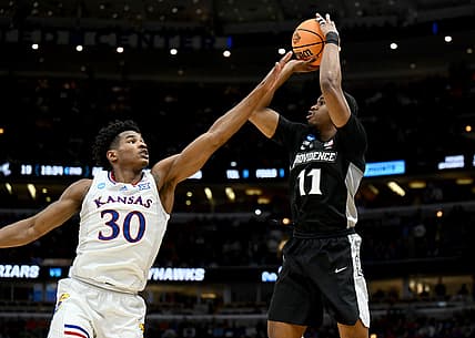 Mar 25, 2022; Chicago, IL, USA; Providence Friars guard A.J. Reeves (11) shoots over Kansas Jayhawks guard Ochai Agbaji (30) during the second half in the semifinals of the Midwest regional of the men's college basketball NCAA Tournament at United Center. Mandatory Credit: Jamie Sabau-USA TODAY Sports