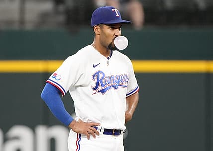 Aug 18, 2022; Arlington, Texas, USA; Texas Rangers second baseman Marcus Semien (2) pauses to blow a bubble between pitches to the Oakland Athletics during the seventh inning at Globe Life Field. Mandatory Credit: Jim Cowsert-USA TODAY Sports