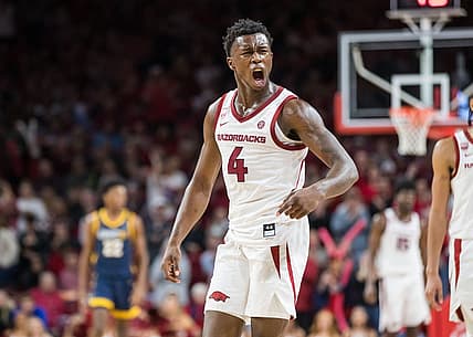 Dec 6, 2022; Fayetteville, Arkansas, USA;  Arkansas Razorbacks guard Davonte Davis (4) yells after a UNC-Greensboro Spartans turnover during the second half at Bud Walton Arena. Arkansas won 65-58. Mandatory Credit: Brett Rojo-USA TODAY Sports