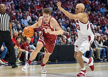 Dec 10, 2022; Tulsa, Oklahoma, USA;  Oklahoma Sooners forward Jacob Groves (34) drives around Arkansas Razorbacks guard Jordan Walsh (13) during the first half at BOK Center. Mandatory Credit: Brett Rojo-USA TODAY Sports