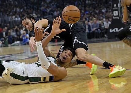 Feb 10, 2023; Los Angeles, California, USA;  Milwaukee Bucks forward Giannis Antetokounmpo (34) gains control of a loose ball and makes a pass as he is defended by Los Angeles Clippers guard Amir Coffey (7) in the first half at Crypto.com Arena. Mandatory Credit: Jayne Kamin-Oncea-USA TODAY Sports