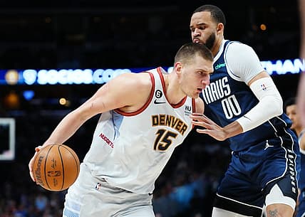 Feb 15, 2023; Denver, Colorado, USA; Dallas Mavericks center JaVale McGee (00) defends Denver Nuggets center Nikola Jokic (15) in the first quarter at Ball Arena. Mandatory Credit: Ron Chenoy-USA TODAY Sports