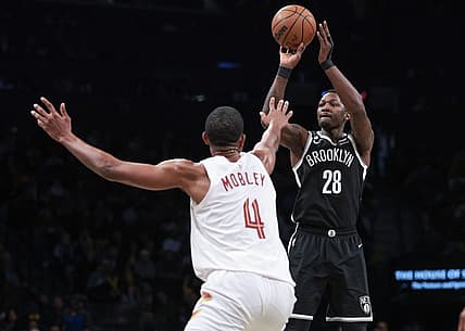 Mar 21, 2023; Brooklyn, New York, USA; Brooklyn Nets forward Dorian Finney-Smith (28) shoots the ball against Cleveland Cavaliers forward Evan Mobley (4) during the second half at Barclays Center. Mandatory Credit: Vincent Carchietta-USA TODAY Sports