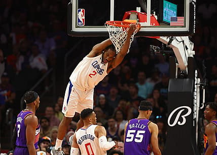Apr 9, 2023; Phoenix, Arizona, USA; Los Angeles Clippers forward Kawhi Leonard (2) hangs from the rim after a slam dunk against the Phoenix Suns in the second half at Footprint Center. Mandatory Credit: Mark J. Rebilas-USA TODAY Sports