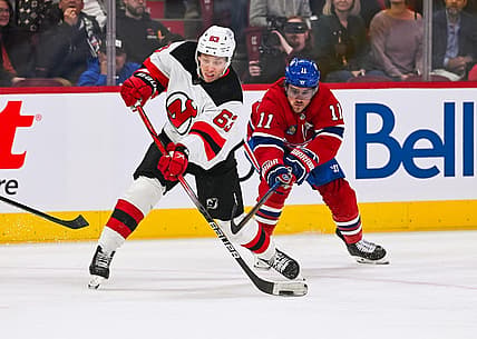 Oct 24, 2023; Montreal, Quebec, CAN; New Jersey Devils left wing Jesper Bratt (63) shoots the puck as Montreal Canadiens right wing Brendan Gallagher (11) defends during the first period at Bell Centre. Mandatory Credit: David Kirouac-USA TODAY Sports
