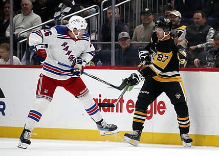 Nov 22, 2023; Pittsburgh, Pennsylvania, USA; New York Rangers left wing Jimmy Vesey (26) and Pittsburgh Penguins center Sidney Crosby (87) battle for the puck during the second period at PPG Paints Arena. Mandatory Credit: Charles LeClaire-USA TODAY Sports