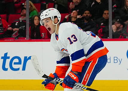 Nov 30, 2023; Raleigh, North Carolina, USA; New York Islanders center Mathew Barzal (13) celebrates his overtime winning goal against the Carolina Hurricanes at PNC Arena. Mandatory Credit: James Guillory-USA TODAY Sports