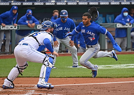 Apr 17, 2021; Kansas City, Missouri, USA;  Toronto Blue Jays right fielder Josh Palacios (77) scores a run past Kansas City Royals catcher Cam Gallagher (36) during the second inning at Kauffman Stadium. Mandatory Credit: Peter Aiken-USA TODAY Sports