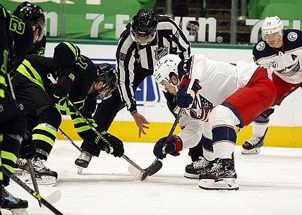 Apr 17, 2021; Dallas, Texas, USA; Dallas Stars center Andrew Cogliano (11) and Columbus Blue Jackets center Jack Roslovic (96) in a face off in the second period  at American Airlines Center. Mandatory Credit: Tim Heitman-USA TODAY Sports