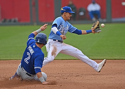 Apr 18, 2021; Kansas City, Missouri, USA; Kansas City Royals shortstop Nicky Lopez (8) forces out Toronto Blue Jays third baseman Joe Panik (2) at second base during the fourth inning at Kauffman Stadium. Mandatory Credit: Peter Aiken-USA TODAY Sports