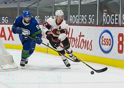 Apr 24, 2021; Vancouver, British Columbia, CAN;  Vancouver Canucks forward J.T. Miller (9) checks Ottawa Senators defenseman Thomas Chabot (72) in the second period at Rogers Arena. Mandatory Credit: Bob Frid-USA TODAY Sports