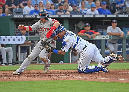 Jun 18, 2021; Kansas City, Missouri, USA;  Kansas City Royals catcher Salvador Perez (13) tags out Boston Red Sox base runner Christian Arroyo (39) attempting to score at home plate during the third inning at Kauffman Stadium. Mandatory Credit: Peter Aiken-USA TODAY Sports