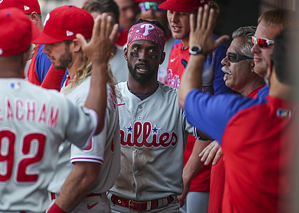 Jun 26, 2021; New York City, New York, USA;  Philadelphia Phillies left fielder Andrew McCutchen (22) is greeted in the dugout after scoring in the second inning against the New York Mets at Citi Field. Mandatory Credit: Wendell Cruz-USA TODAY Sports