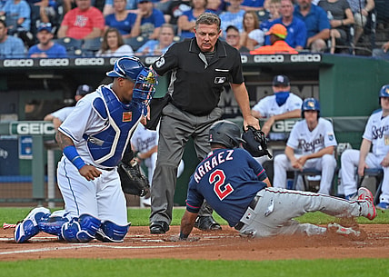 Jul 2, 2021; Kansas City, Missouri, USA;  Minnesota Twins second baseman Luis Arraez (2) slides home to score a run against Kansas City Royals catcher Salvador Perez (13) during the first inning at Kauffman Stadium. Mandatory Credit: Peter Aiken-USA TODAY Sports