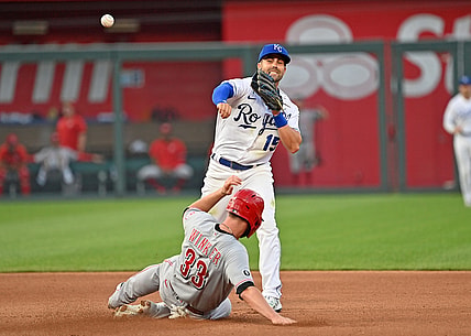 Jul 5, 2021; Kansas City, Missouri, USA;  Kansas City Royals second baseman Whit Merrifield (15) completes a double play with a throw to first over Cincinnati Reds designated hitter Jesse Winker (33) during the fourth inning at Kauffman Stadium. Mandatory Credit: Peter Aiken-USA TODAY Sports