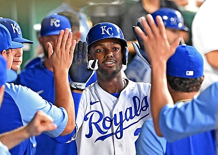 Jul 6, 2021; Kansas City, Missouri, USA;  Kansas City Royals center fielder Michael A. Taylor (2) celebrates in the dugout after hitting a solo home run during the fifth inning against the Cincinnati Reds at Kauffman Stadium. Mandatory Credit: Peter Aiken-USA TODAY Sports