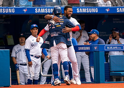 Aug 1, 2021; Toronto, Ontario, CAN; Toronto Blue Jays second baseman Santiago Espinal (5) hugs teammate Teoscar Hernandez (37) after hitting a home run against the Kansas City Royals during the fourth inning at Rogers Centre. Mandatory Credit: Kevin Sousa-USA TODAY Sports