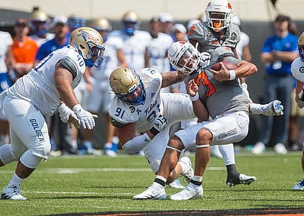 Sep 11, 2021; Stillwater, Oklahoma, USA;  Oklahoma State Cowboys quarterback Spencer Sanders (3) is sacked by Tulsa Golden Hurricane defensive lineman Cullen Wick (91) as defensive lineman Jaxon Player (90) moves in during the second quarter  at Boone Pickens Stadium. Mandatory Credit: Brett Rojo-USA TODAY Sports
