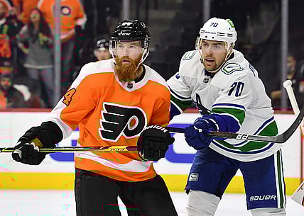 Oct 15, 2021; Philadelphia, Pennsylvania, USA; Philadelphia Flyers defenseman Ryan Ellis (94) and Vancouver Canucks left wing Tanner Pearson (70) battle at Wells Fargo Center. Mandatory Credit: Eric Hartline-USA TODAY Sports