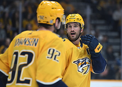 Dec 4, 2021; Nashville, Tennessee, USA; Nashville Predators defenseman Roman Josi (59) talks positioning with center Ryan Johansen (92) on a face off in overtime against the Montreal Canadiens at Bridgestone Arena. Mandatory Credit: Christopher Hanewinckel-USA TODAY Sports