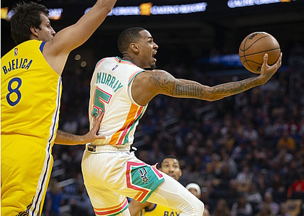 Mar 20, 2022; San Francisco, California, USA; San Antonio Spurs guard Dejounte Murray (5) drives to the basket past Golden State Warriors forward Nemanja Bjelica (8) during the first quarter at Chase Center. Mandatory Credit: D. Ross Cameron-USA TODAY Sports