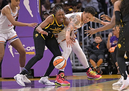 May 19, 2023; Los Angeles, California, USA;  Los Angeles Sparks forward Nneka Ogwumike (30) and Phoenix Mercury center Brittney Griner (42) reach for a loose ball in the second half at Crypto.com Arena. Mandatory Credit: Jayne Kamin-Oncea-USA TODAY Sports