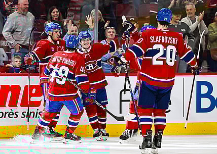 Oct 21, 2023; Montreal, Quebec, CAN; Montreal Canadiens right wing Cole Caufield (22) celebrates his winning goal against the Washington Capitals with his teammates during overtime at Bell Centre. Mandatory Credit: David Kirouac-USA TODAY Sports